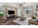 Open living room with dark flooring, a ceiling fan, and a modern sofa at 22056 N 32Nd Ave, Phoenix, AZ 85027