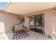 Comfortable covered patio with outdoor seating, plants, neutral walls, and sliding glass door at 22056 N 32Nd Ave, Phoenix, AZ 85027