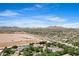 Expansive view highlighting a beautiful home in a neighborhood nestled amidst desert terrain and mountains at 24434 S 201St Ct, Queen Creek, AZ 85142