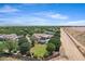 Extensive aerial view displaying an estate with a vibrant green backyard and a luxury pool at 24434 S 201St Ct, Queen Creek, AZ 85142