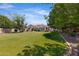 Expansive backyard with a well-kept lawn and a view of the home's exterior and pool area at 24434 S 201St Ct, Queen Creek, AZ 85142