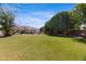Lush backyard featuring green grass, mature trees, and a view of the house with a pool at 24434 S 201St Ct, Queen Creek, AZ 85142
