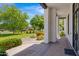 Stylish front porch area with stone pillars, green landscaping, and a brick walkway at 24434 S 201St Ct, Queen Creek, AZ 85142