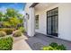 Inviting front entrance with stone accents, manicured landscaping, and modern lighting at 24434 S 201St Ct, Queen Creek, AZ 85142