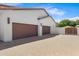 Spacious three-car garage with brown doors and well-maintained driveway at 24434 S 201St Ct, Queen Creek, AZ 85142