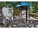 Shaded pergola-covered patio with stylish pavers and landscaped surroundings, ideal for relaxation at 24434 S 201St Ct, Queen Creek, AZ 85142