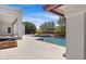 An inviting pool area with stylish stone details and a jacuzzi covered by a protective layer at 24434 S 201St Ct, Queen Creek, AZ 85142