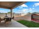 Backyard featuring a covered patio, desert landscaping, and privacy wall at 25119 N 134Th Dr, Peoria, AZ 85383