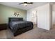 Well-lit bedroom showcasing green accent wall, plush gray carpeting and a queen-size bed at 25119 N 134Th Dr, Peoria, AZ 85383