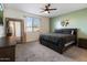 Bright bedroom featuring a queen bed, gray carpet, and an abundance of natural light at 25119 N 134Th Dr, Peoria, AZ 85383