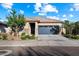 Charming single-story home featuring a gray garage door, stone accents, and well-maintained landscaping at 25119 N 134Th Dr, Peoria, AZ 85383