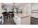Open-concept kitchen with a large island, granite countertops, and seamless flow to the dining and living areas at 25119 N 134Th Dr, Peoria, AZ 85383