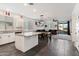 Open-concept kitchen flows into the dining and living area, featuring a central island with granite countertop at 25119 N 134Th Dr, Peoria, AZ 85383