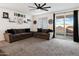 Inviting living room with plush carpeting, a modern ceiling fan, and sliding glass door to the backyard at 25119 N 134Th Dr, Peoria, AZ 85383