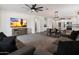 Spacious open concept living area features a large sectional and view to the kitchen and dining areas at 25119 N 134Th Dr, Peoria, AZ 85383
