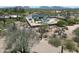 Aerial view of the home showcasing beautiful desert landscape, the home, pool, trampoline, and mountain views at 26626 N 70Th Pl, Scottsdale, AZ 85266