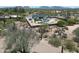 Stunning aerial view of a desert home with a backyard pool and lush landscaping and mountain views at 26626 N 70Th Pl, Scottsdale, AZ 85266