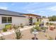 Charming backyard with desert landscaping, stone pathway, and modern architectural details at 26626 N 70Th Pl, Scottsdale, AZ 85266