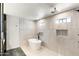 Modern bathroom is complete with a sleek soaking tub and tiled walk-in shower at 26626 N 70Th Pl, Scottsdale, AZ 85266