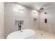 Modern bathroom is complete with a sleek soaking tub and tiled walk-in shower at 26626 N 70Th Pl, Scottsdale, AZ 85266