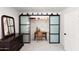 Bright bedroom with modern sliding closet doors and a vanity area with chair, enhancing its functionality at 26626 N 70Th Pl, Scottsdale, AZ 85266
