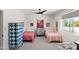 Bright bedroom featuring two twin beds, ample natural light, and unique decor, creating an inviting atmosphere at 26626 N 70Th Pl, Scottsdale, AZ 85266