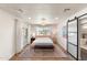 Bright bedroom boasts wood floors, white walls, and sliding door to the bathroom at 26626 N 70Th Pl, Scottsdale, AZ 85266