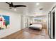 Bright bedroom features a large window, wood floors, and access to the backyard patio at 26626 N 70Th Pl, Scottsdale, AZ 85266