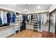 Walk-in closet offers ample shelving, storage options, and natural light at 26626 N 70Th Pl, Scottsdale, AZ 85266