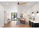 Bright dining area with stylish lighting, wood floors, and backyard access through glass doors at 26626 N 70Th Pl, Scottsdale, AZ 85266
