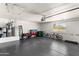 Spacious three car garage with painted floor and ample storage, perfect for vehicles and hobbies at 26626 N 70Th Pl, Scottsdale, AZ 85266