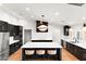 Modern kitchen with an island, stainless steel appliances, and elegant black cabinetry at 26626 N 70Th Pl, Scottsdale, AZ 85266