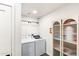 Functional laundry room featuring modern washer and dryer, storage, and ample space at 26626 N 70Th Pl, Scottsdale, AZ 85266