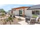 Inviting outdoor patio area with modern seating, desert landscaping, and stylish pergola at 26626 N 70Th Pl, Scottsdale, AZ 85266
