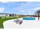 Sparkling pool and lounge chairs for relaxation on travertine patio with artificial turf and a modern home in the background at 26626 N 70Th Pl, Scottsdale, AZ 85266