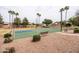Community basketball court surrounded by green spaces and landscaping with bench seating for relaxation at 2853 E Cathy Dr, Gilbert, AZ 85296