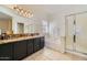 Bright bathroom with double sink vanity, soaking tub, and separate glass-enclosed shower at 2853 E Cathy Dr, Gilbert, AZ 85296
