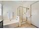 Well-lit bathroom with a tub, separate shower, and tiled floor for a clean and modern look at 2853 E Cathy Dr, Gilbert, AZ 85296