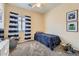 Bright bedroom with a twin bed, ceiling fan, and a window with striped curtains at 2853 E Cathy Dr, Gilbert, AZ 85296
