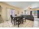 Dining area with dark wood table and seating, open to the living area with natural light at 2853 E Cathy Dr, Gilbert, AZ 85296