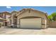 Home exterior features a beige stucco finish, with a two-car garage and an arched entryway at 2853 E Cathy Dr, Gilbert, AZ 85296