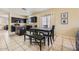 Kitchen and dining area featuring dark cabinets, granite countertops, and neutral tile flooring at 2853 E Cathy Dr, Gilbert, AZ 85296