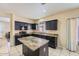 Modern kitchen with granite countertops, black cabinets, and an island at 2853 E Cathy Dr, Gilbert, AZ 85296