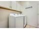 Functional laundry room with white cabinets and modern, front-loading washer and dryer at 2853 E Cathy Dr, Gilbert, AZ 85296