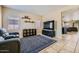 Bright living room with tile flooring, blue patterned rug, and comfortable seating at 2853 E Cathy Dr, Gilbert, AZ 85296