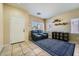 Cozy living room features a comfortable blue sofa, tile floors, and bright natural light at 2853 E Cathy Dr, Gilbert, AZ 85296