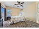 Spacious main bedroom with neutral walls, ceiling fan, and sliding glass door to the outside at 2853 E Cathy Dr, Gilbert, AZ 85296