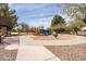 Colorful playground with swings, slides, and climbing structures, set in a sand-filled area at 2853 E Cathy Dr, Gilbert, AZ 85296