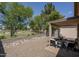 Relaxing covered patio area with rock landscaping and view of the green community space at 3098 E Stottler Dr, Gilbert, AZ 85296