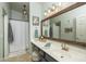 Bright bathroom with blue vanity, white countertop, large mirror, and shower with white curtains at 3098 E Stottler Dr, Gilbert, AZ 85296